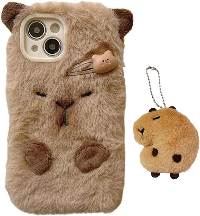 Fuzzy capybara iPhone 14 case with 3D plush ears, embroidered face, and matching plush keychain pendant.