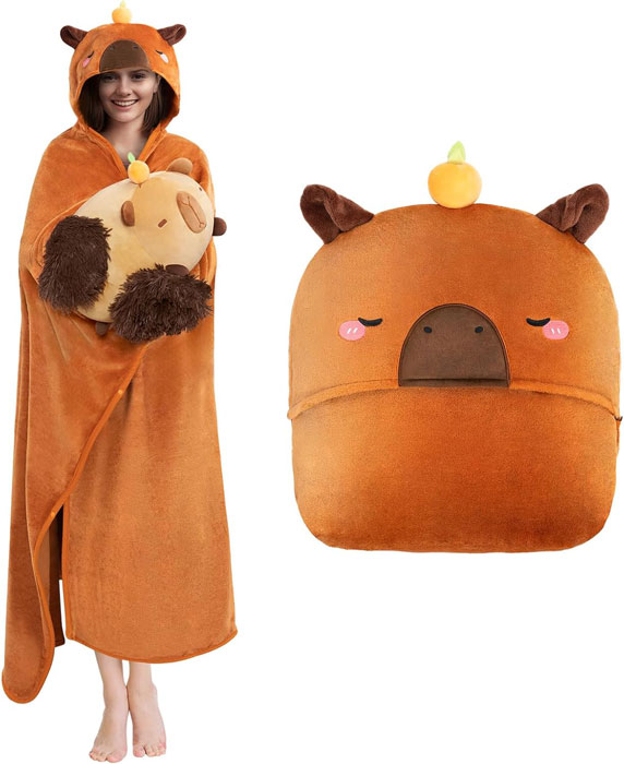 Oversized wearable capybara hoodie blanket in flannel with plush pillow storage, modeled by smiling adult, perfect cozy gift for capybara lovers.