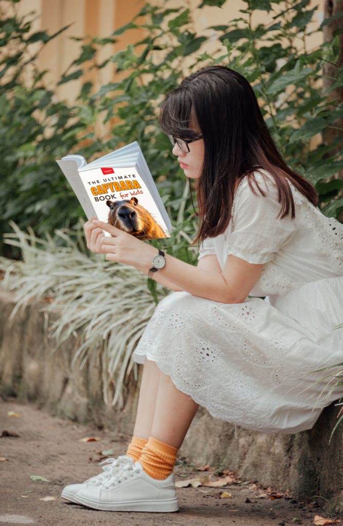 child reading the ultimate capybara book for kids 
